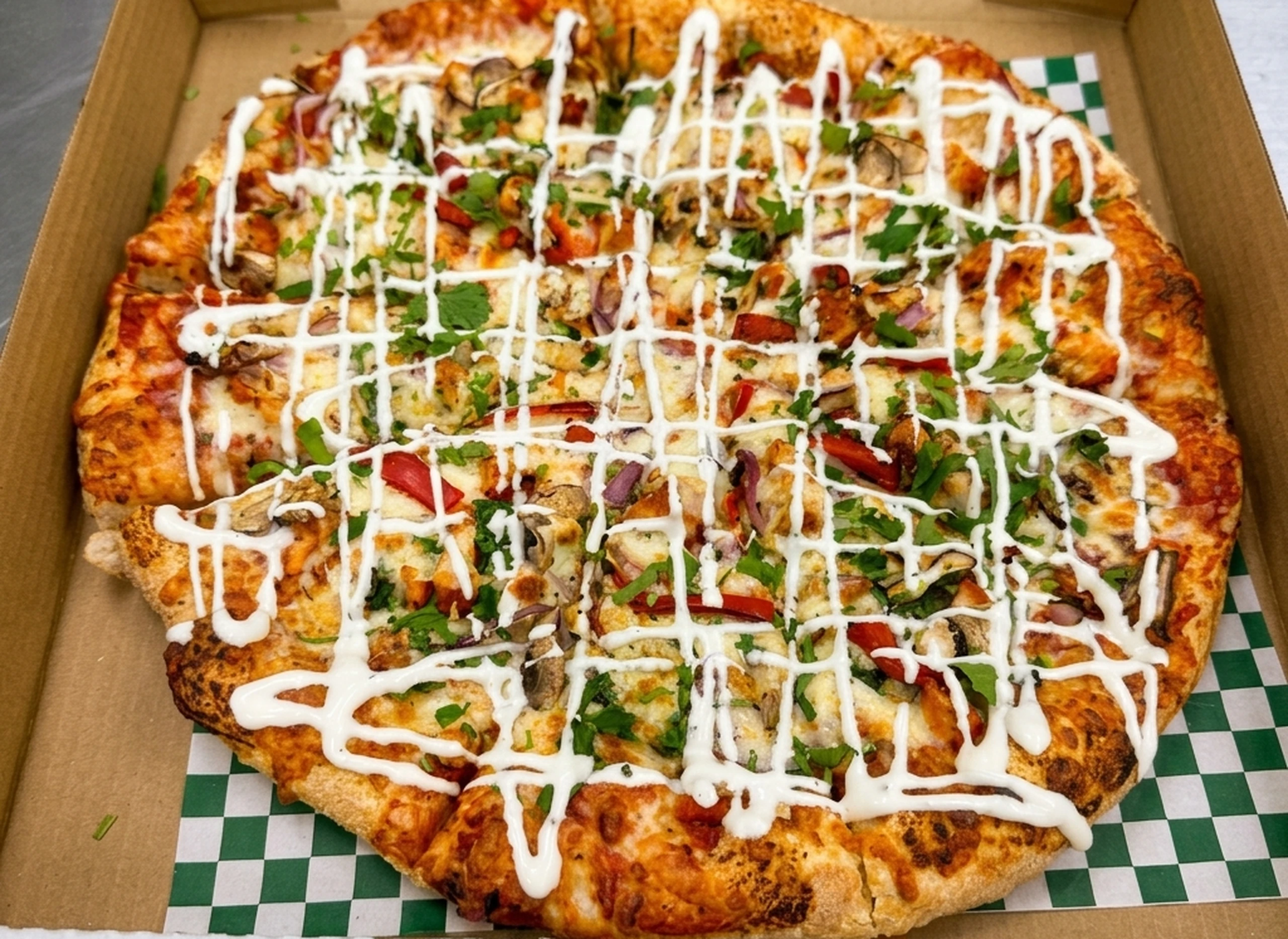 Butter chicken and tandoori chicken pizza at Calzone Corner Takeout & Tiffin Service Calgary