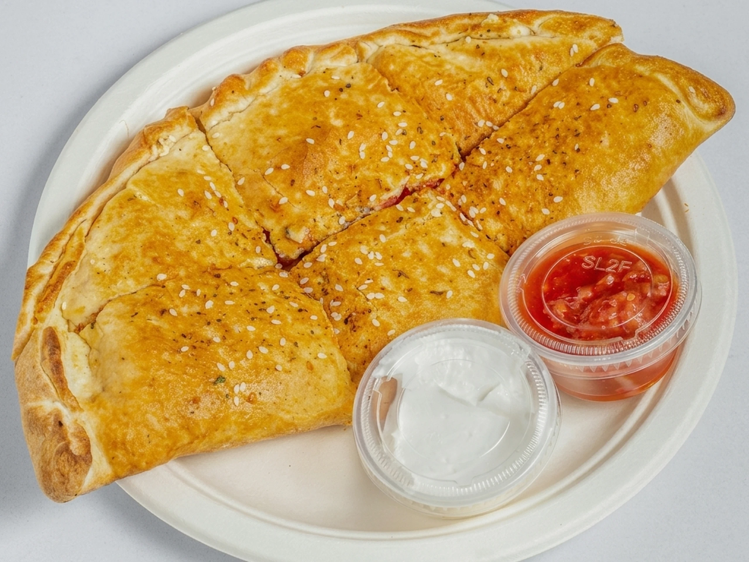 Stuffed Punjabi fusion calzones with masala paneer and chicken fillings at Calzone Corner Calgary NE