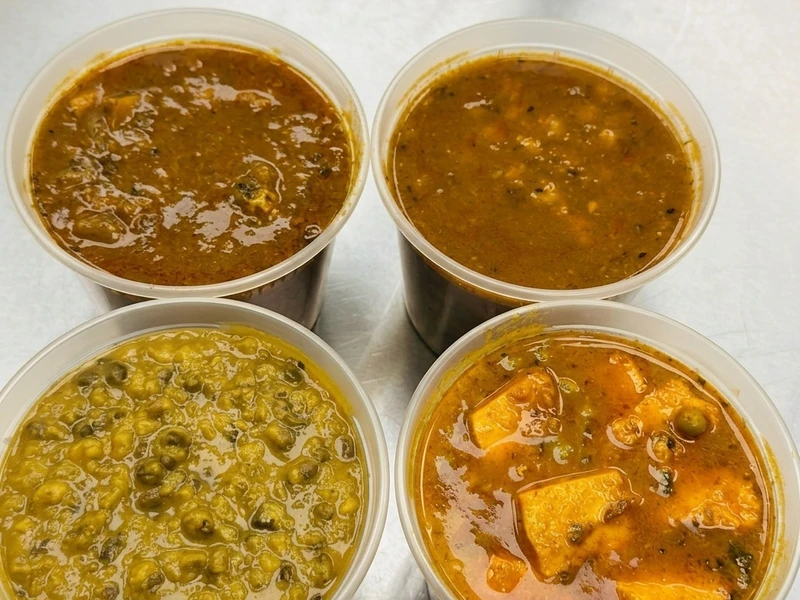 High-protein Indian tiffin meal combo with sabji, roti and rice at Calzone Corner Calgary