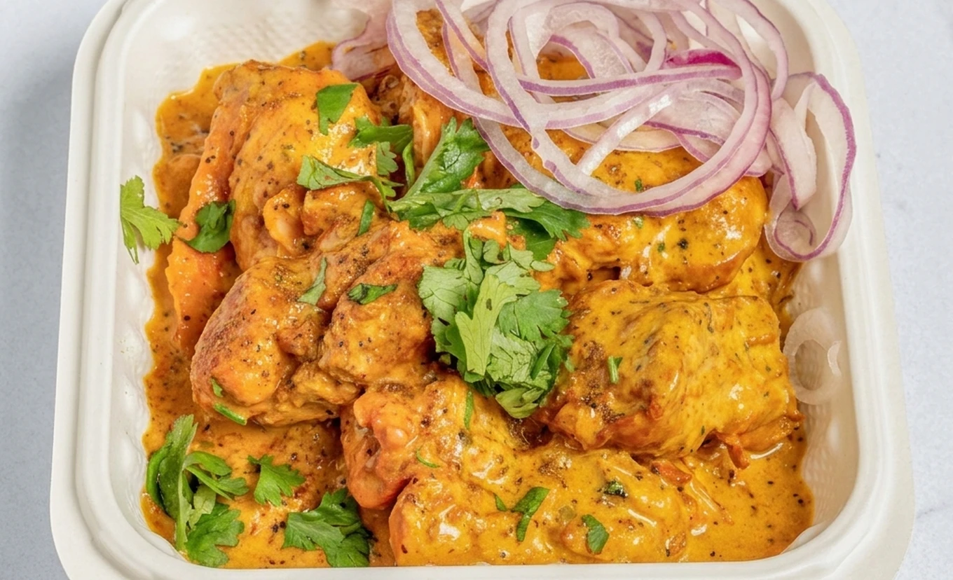 Butter chicken and rice tiffin meal at Calzone Corner Calgary NE - high-protein home-style Indian tiffin combo