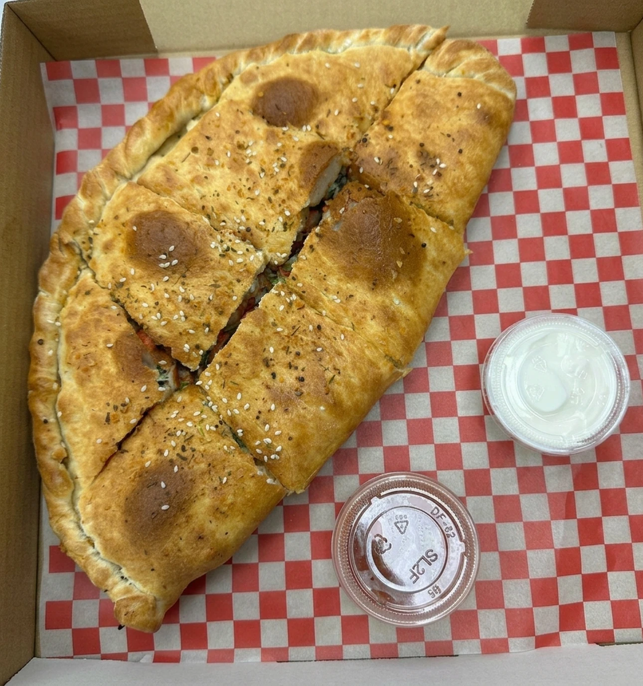 Makhani fish calzone at Calzone Corner Calgary - fusion calzone special with creamy makhani fish filling