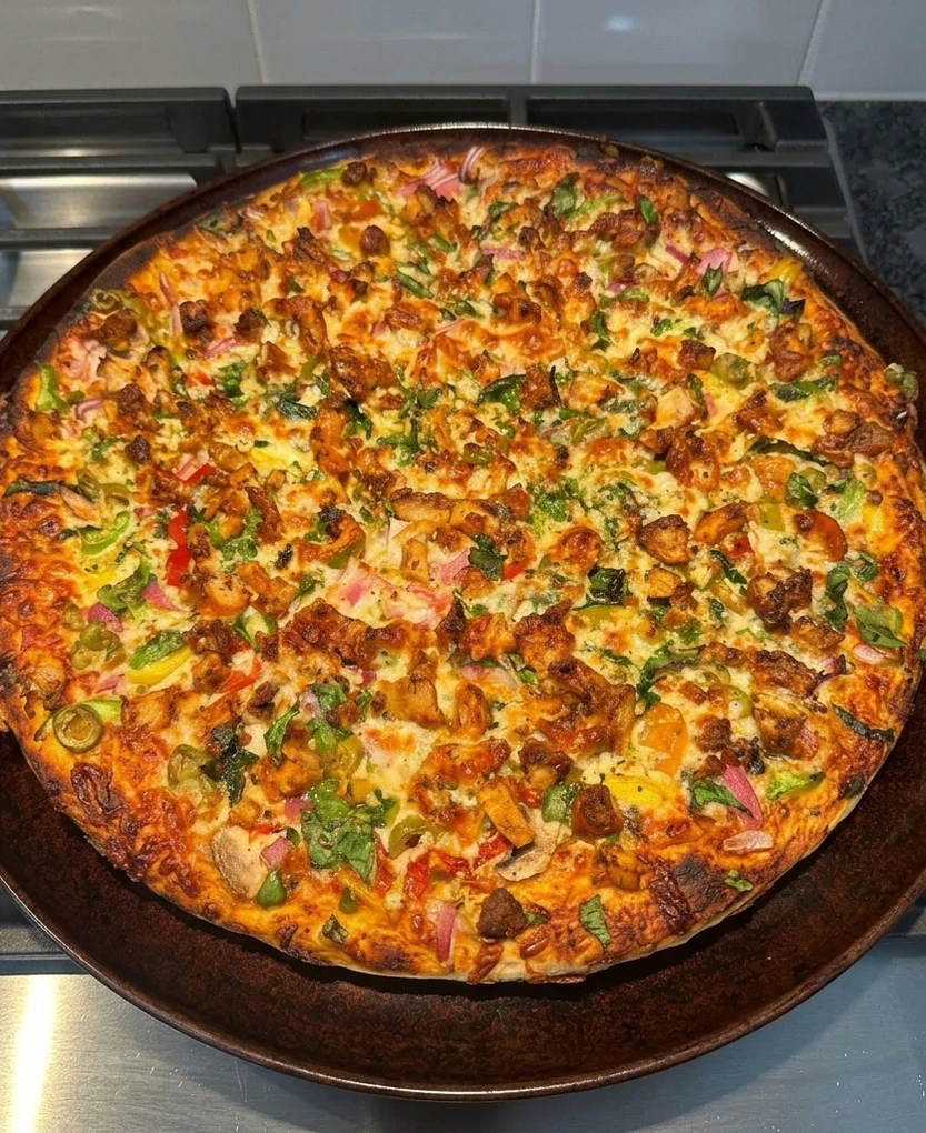 Tandoori chicken pizza at Calzone Corner Calgary NE - smoky tandoori chicken with masala-style toppings